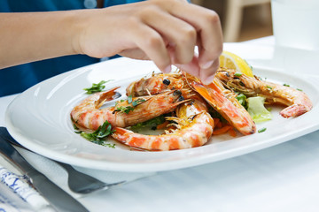 Plate with colorful king prawns in restaurant. Sea food concept.