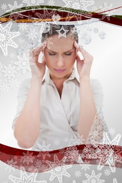 Composite image of portrait of a businesswoman having a headache