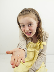 small girl showing gap in teeth
