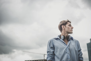 young model hansome blonde man with headphones