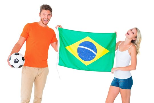 Excited Football Fan Couple Holding Brazil Flag