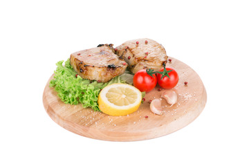 Grilled meat on wooden platter.
