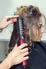 Fototapeta premium woman in a beauty salon doing hair