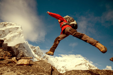 Hiker jumps on the rock near Everest in Nepal - obrazy, fototapety, plakaty
