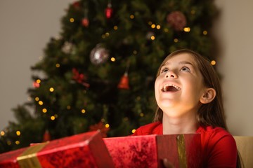 Little girl opening a magical christmas gift