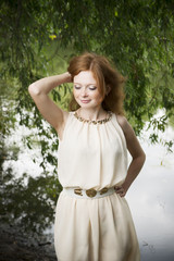 Portrait of redhead girl on nature