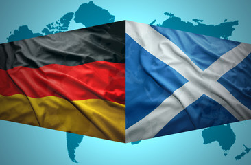 Waving Scottish and German flags