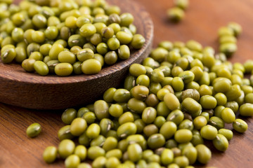 Mung beans over wooden spoon