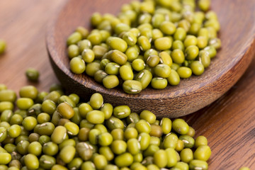 Mung beans over wooden spoon