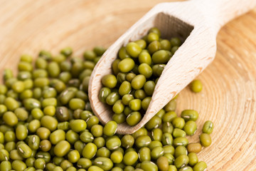 Mung beans over wooden spoon