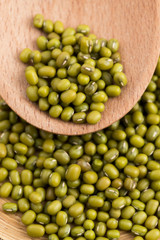 Mung beans over wooden spoon