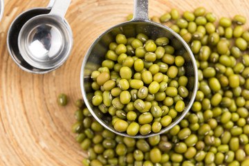 Mung beans over wooden spoon