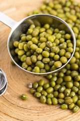 Mung beans over wooden spoon
