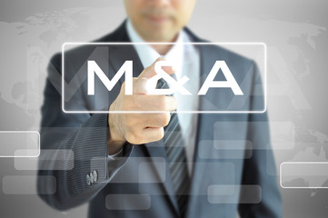 Businessman hand touching M & A sign on virtual screen 