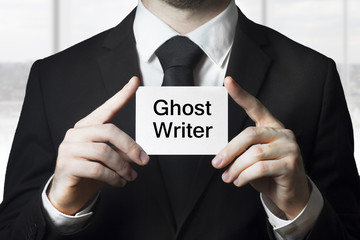 businessman holding sign ghost writer