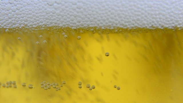Extreme close up of beer poured into glass
