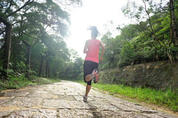 fitness woman runner running on stone trail