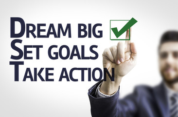 Business man pointing a motivational text