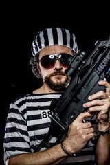 Security.Prison riot concept. Man holding a machine gun, prisone