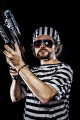 Security.Prison riot concept. Man holding a machine gun, prisone