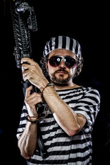Security.Prison riot concept. Man holding a machine gun, prisone