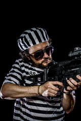 Attack .Prison riot concept. Man holding a machine gun, prisoner