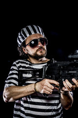 Force .Prison riot concept. Man holding a machine gun, prisoner