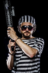 Torture .Prison riot concept. Man holding a machine gun, prisone