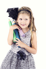 Beautiful happy little girl carrying big crayons