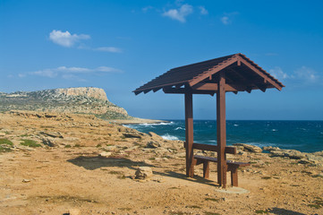 bench with roof near sea