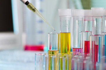 pipette dosing in tubes with equipment Laboratory in workbench