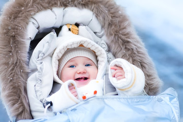 Baby in stroller in a winter park
