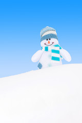Happy winter snowman against blue sky