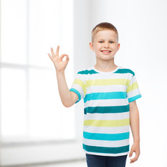 little boy in casual clothes making ok gesture