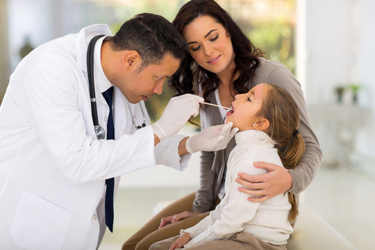 pediatric doctor examining little patient