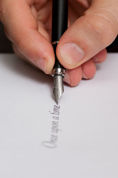 Fountain pen writing the words "Once upon a time"