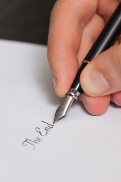 Fountain pen writing the words "The End"