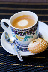 Cup of freshly brewed tea and a cookie