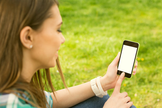 Teenage girl with smart phone outdoors. Mockup.
