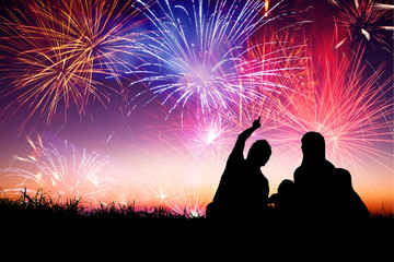 happy family sitting on floor and watching the fireworks - Powered by Adobe