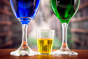 Glasses with green and blue cocktail yellow shot