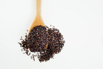 Thai black jasmine rice (Rice berry) in wooden spoon on white ba