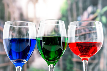 Glasses with blue red and green liquid cocktails