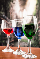 Glasses with blue red and green liquid cocktails