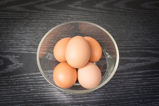 Group of brown eggs on wooden background