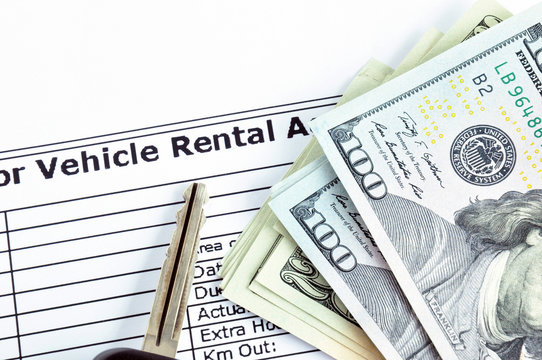 Money & car key on Vehicle Rental Agreement paper