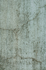 Rough textured blue wall with stains