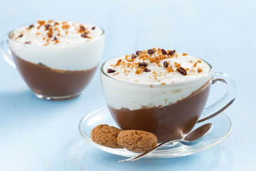 dessert with chocolate, cream and amaretti on a blue background