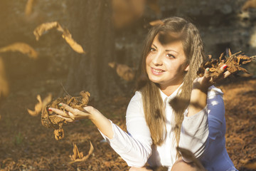 Beautiful young hispanic woman in autumn park