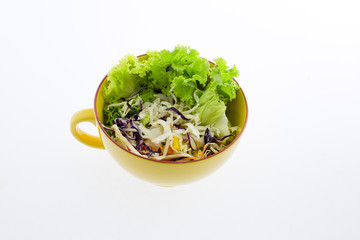 fresh vegetable salad in transparent bowl isolated on white